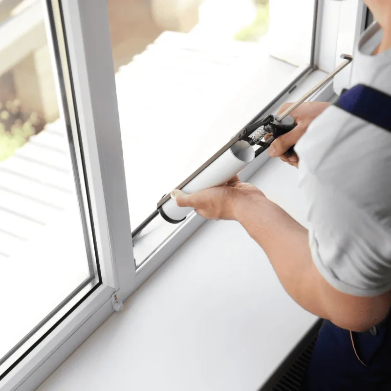 Professional technician sealing a window frame during glass repair. Timely window glass repair and replacement in Toronto helps improve energy efficiency, prevent drafts, and enhance home safety and comfort. 24-hour emergency services available across the GTA.